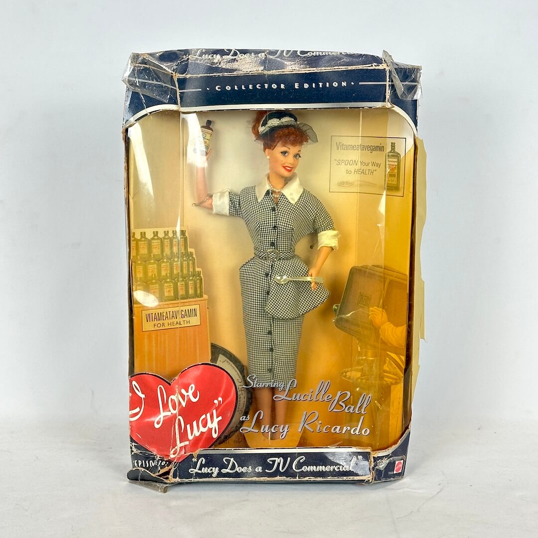 Collectible doll in packaging with 'I Love Lucy' branding on a white background