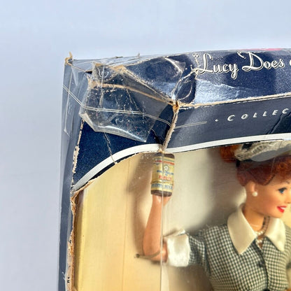 Vintage doll in packaging with visible wear on the box
