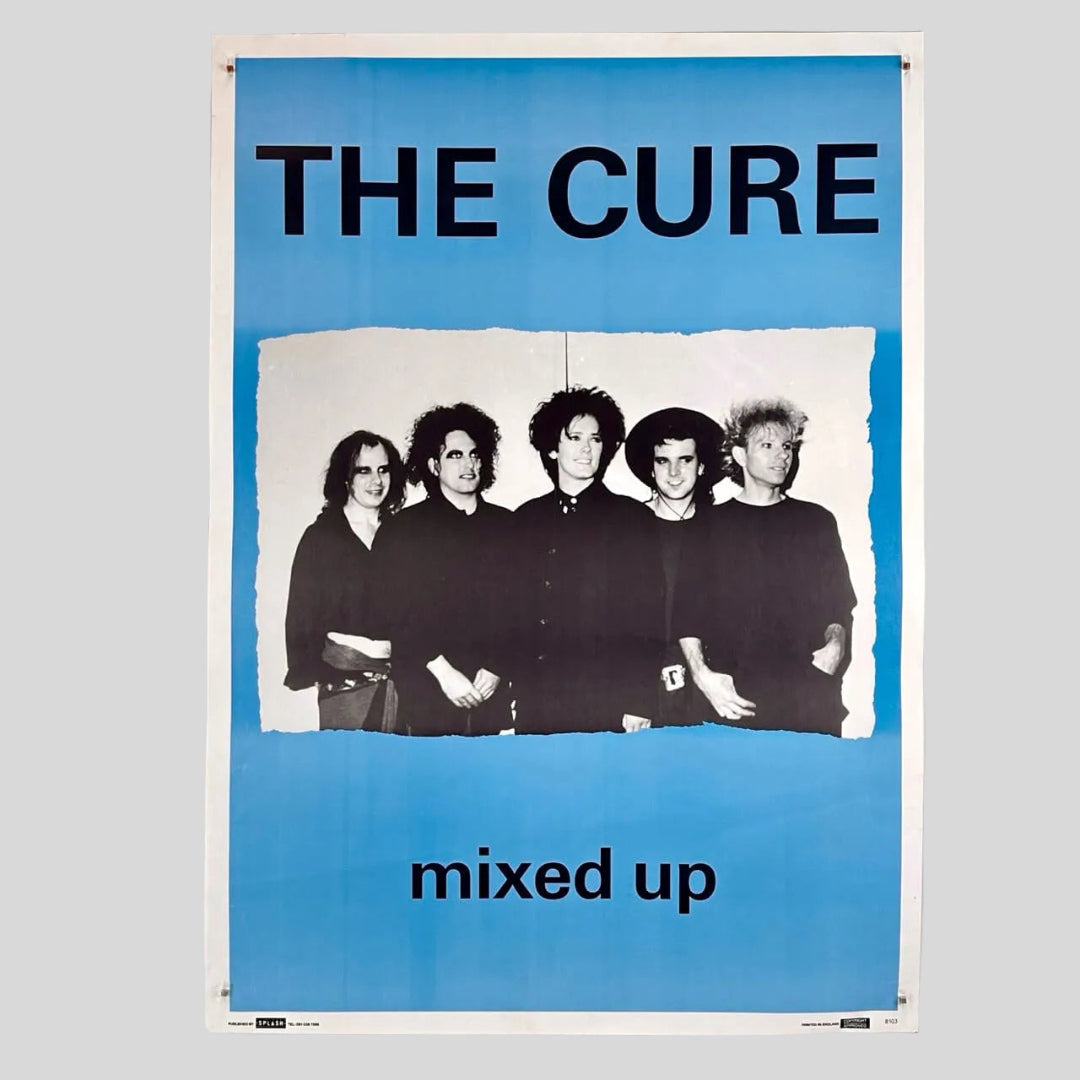 Poster of The Cure with band members and 'mixed up' text on a blue background