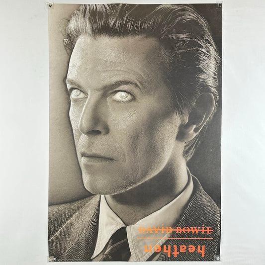 David Bowie promo poster of Bowie's face with glowing eyes in black and white. 