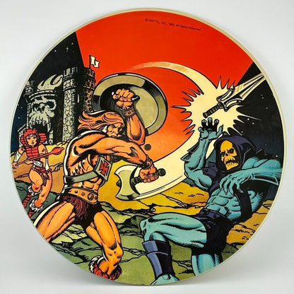 Record disc with battle scene between He-Man & Skeletor on red background. Castle Grayskull & She-Ra in background. 