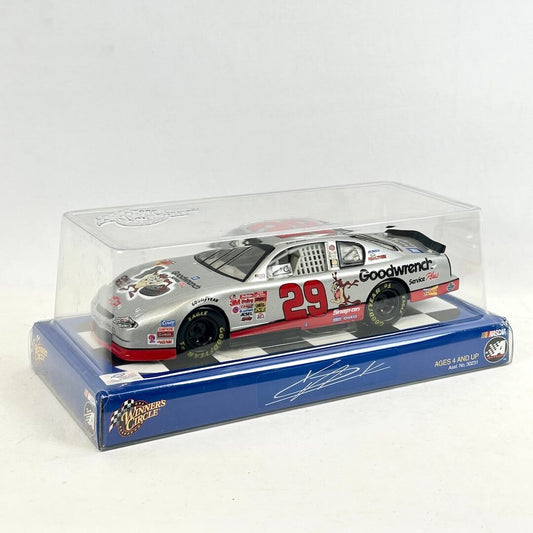 Model car in a clear display case with a blue base on a white background