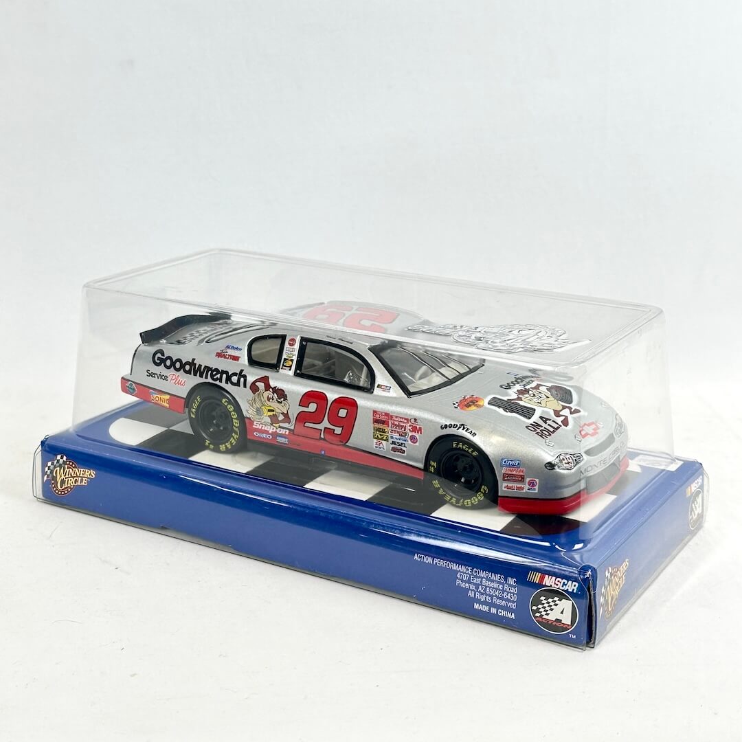 Model car in a clear display case with a blue base on a white background