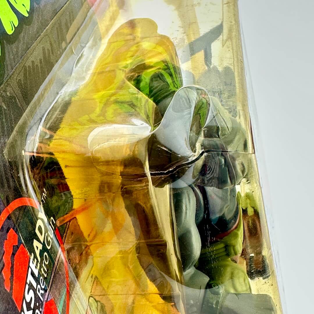 Clear plastic packaging with a product inside, reflecting light and colors.