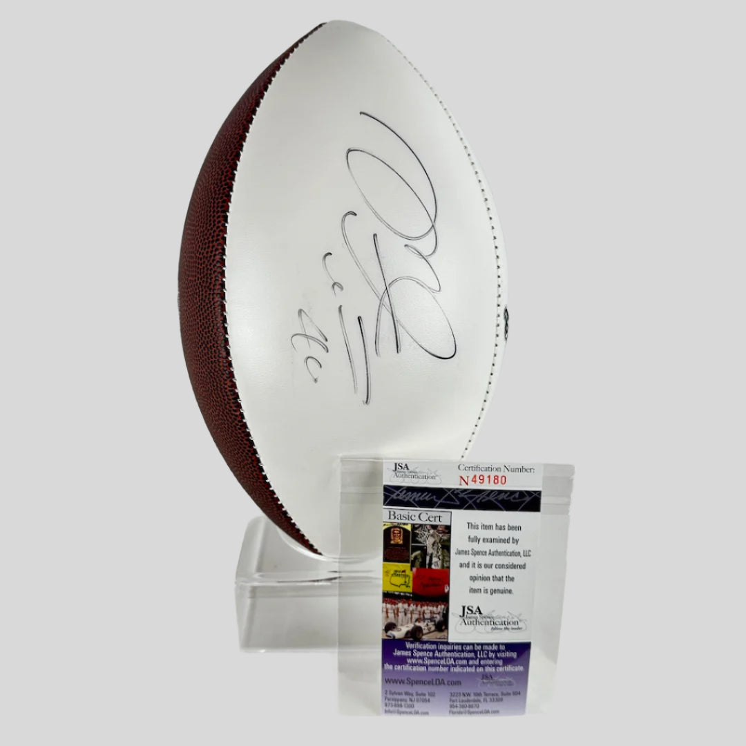 Signed football with a PSA/DNA authentication card on a white background
