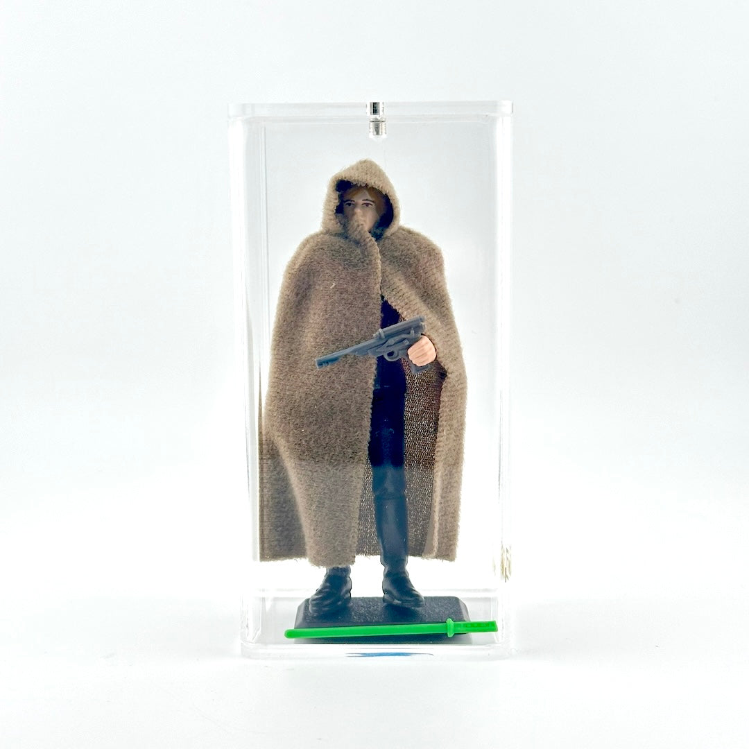 Action figure in a brown cloak with a gun, held in a clear display case.