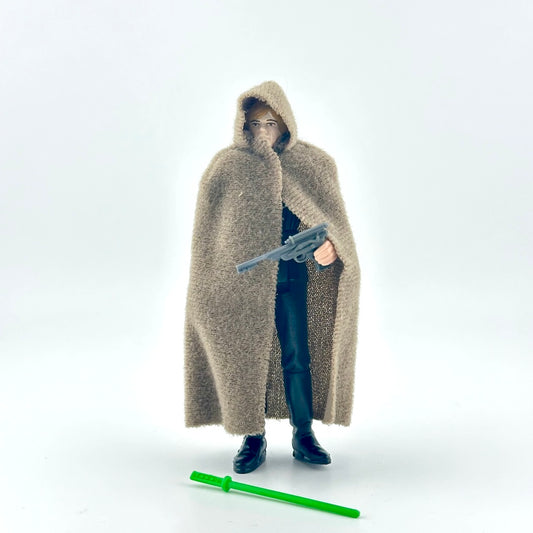 Action figure in a long beige cloak holding a gun on a white background