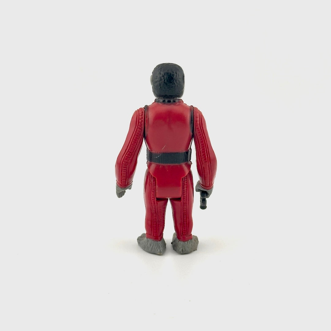 Toy figure in a red suit on a white background