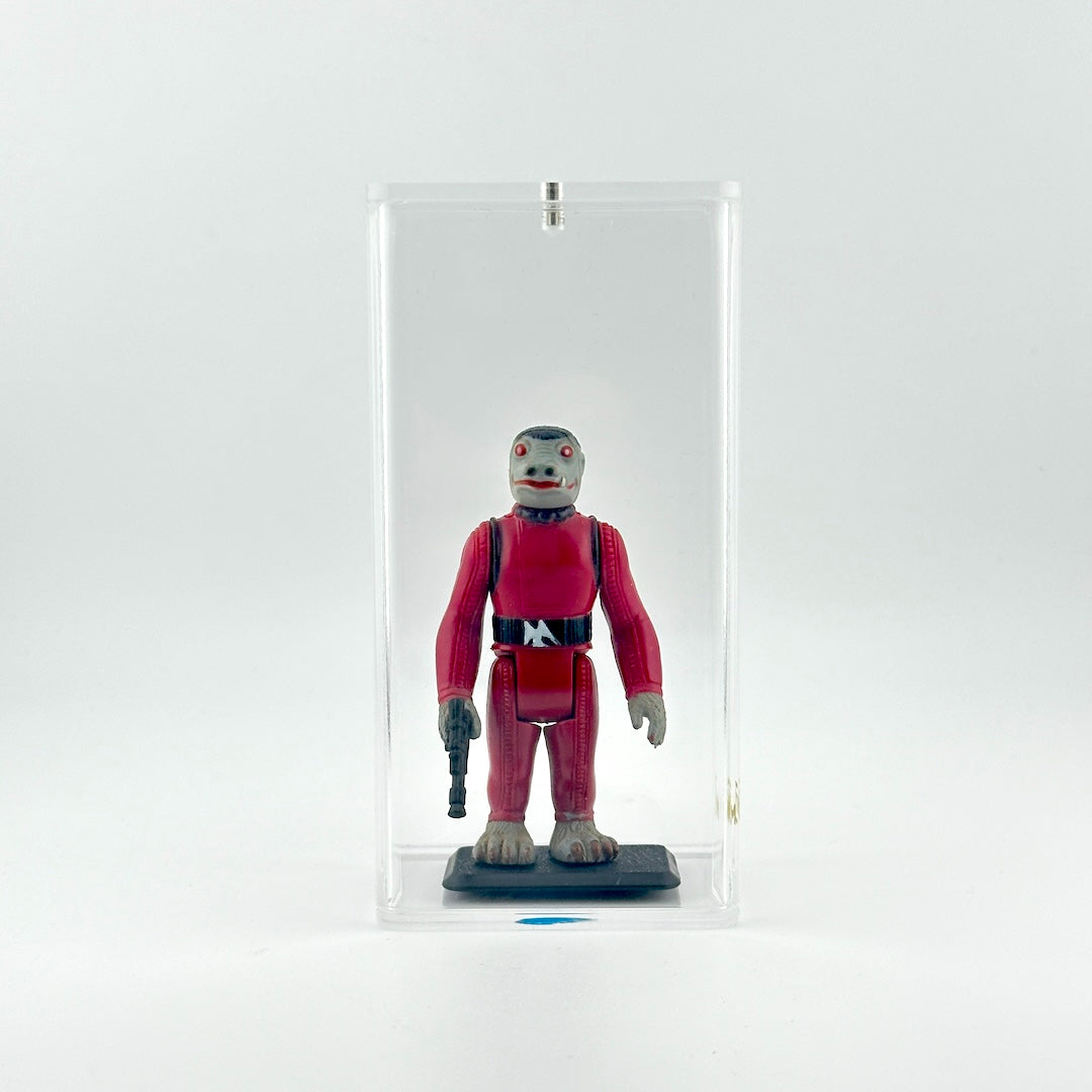 Action figure in a red suit with gun inside a clear display case on a white background