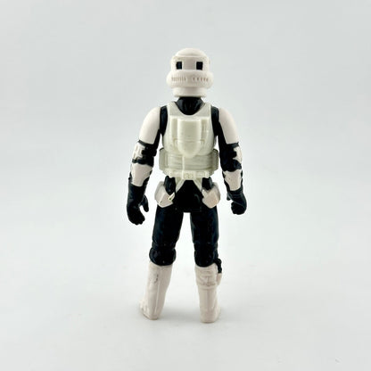 Toy figure in a white and black costume on a light gray background