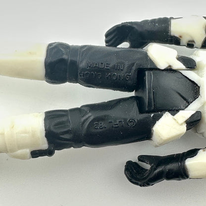Close-up of a toy figure's hand with black and white details, showing 'Made in Hong Kong' text.