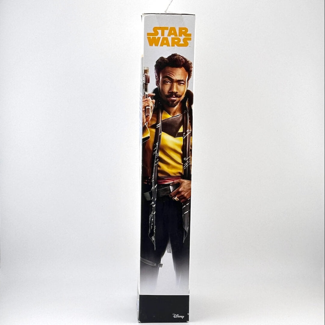 Star Wars toy figure packaging with character holding a gun on a white background