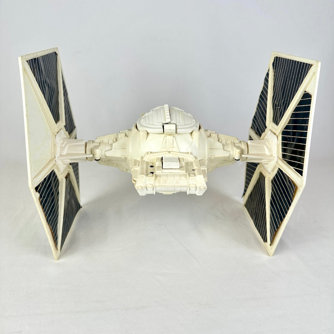 Back view of ship with sphere cockpit and hexagonal wings on either side. 
