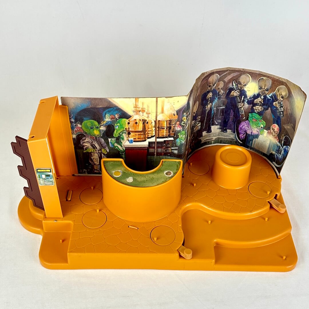 Star Wars Cantina playset with orange base and background with colorful characters against white backdrop. Overhead view.