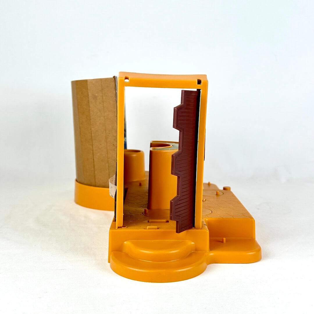 Star Wars Cantina playset with orange base and background with colorful characters against white backdrop. View of doors.