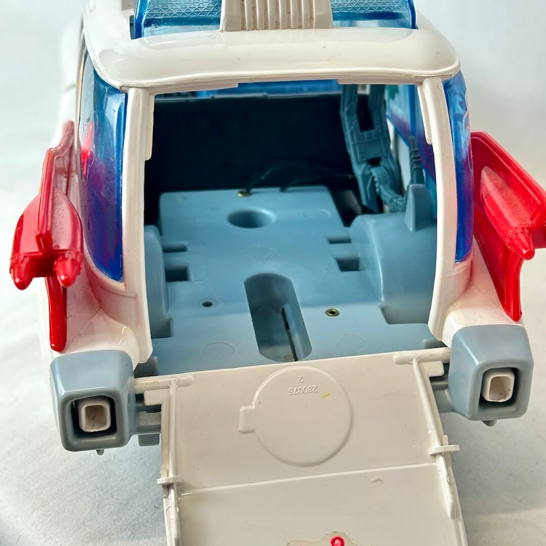 Close-up of a toy vehicle with open doors on a light gray background
