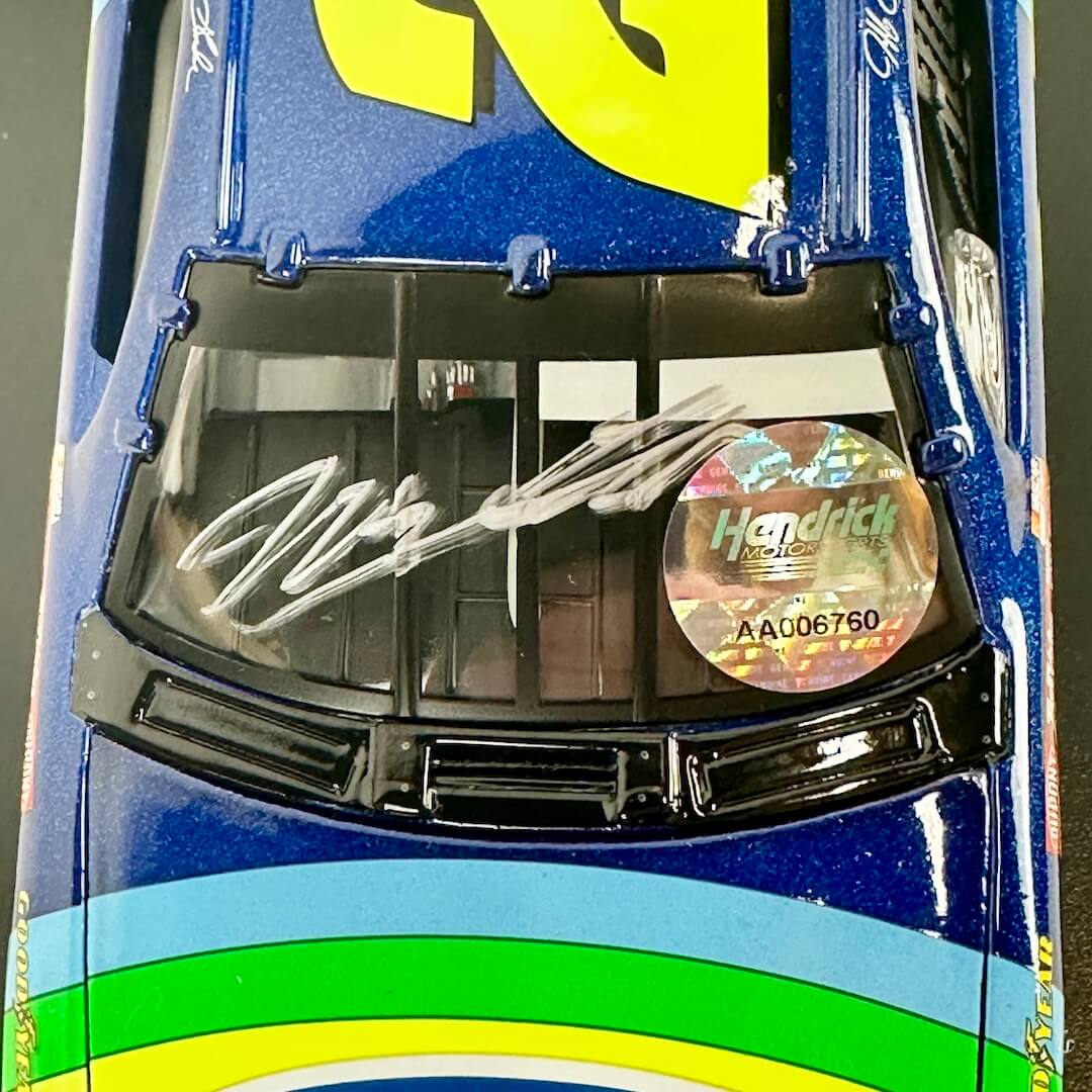 Close-up of signature on windshield and holographic sticker of authenticity. 