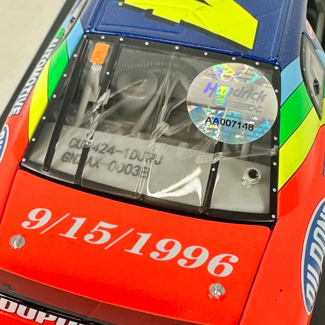 Close-up of signature on rear window and holographic sticker of authenticity. 