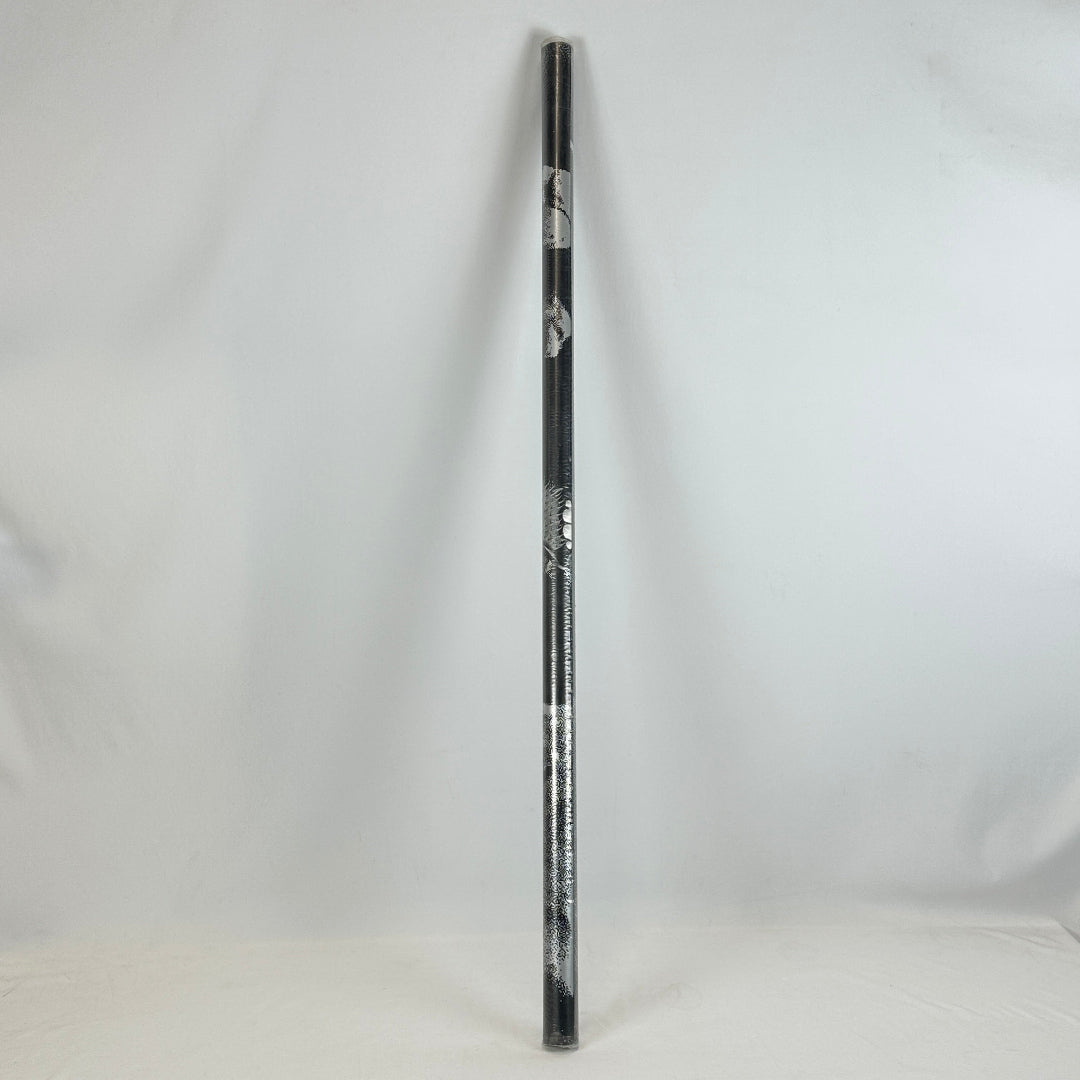 Plastic sleeved, rolled poster with gray details leaning against white wall. 