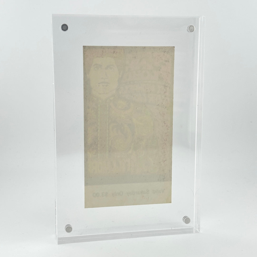 A clear acrylic picture frame with rounded corners and four visible silver screws, holding a faded beige portrait print against a light gray studio background.