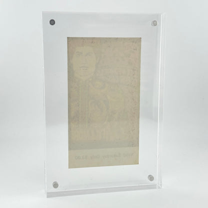 A clear acrylic picture frame with rounded corners and four visible silver screws, holding a faded beige portrait print against a light gray studio background.