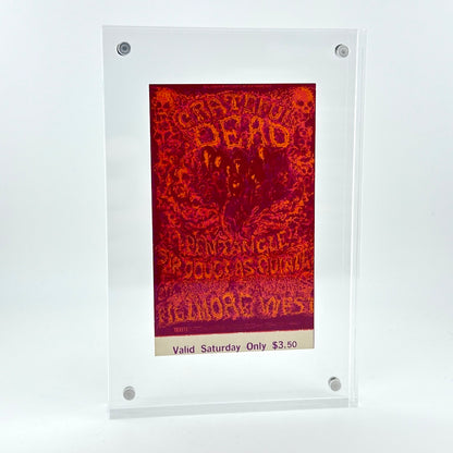 A clear acrylic display frame holding a red and orange psychedelic concert poster that reads 'Grateful Dead'.