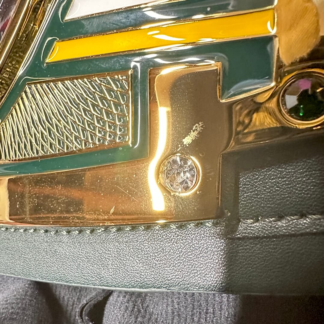 Scratch by bottom right screw on center plate. 