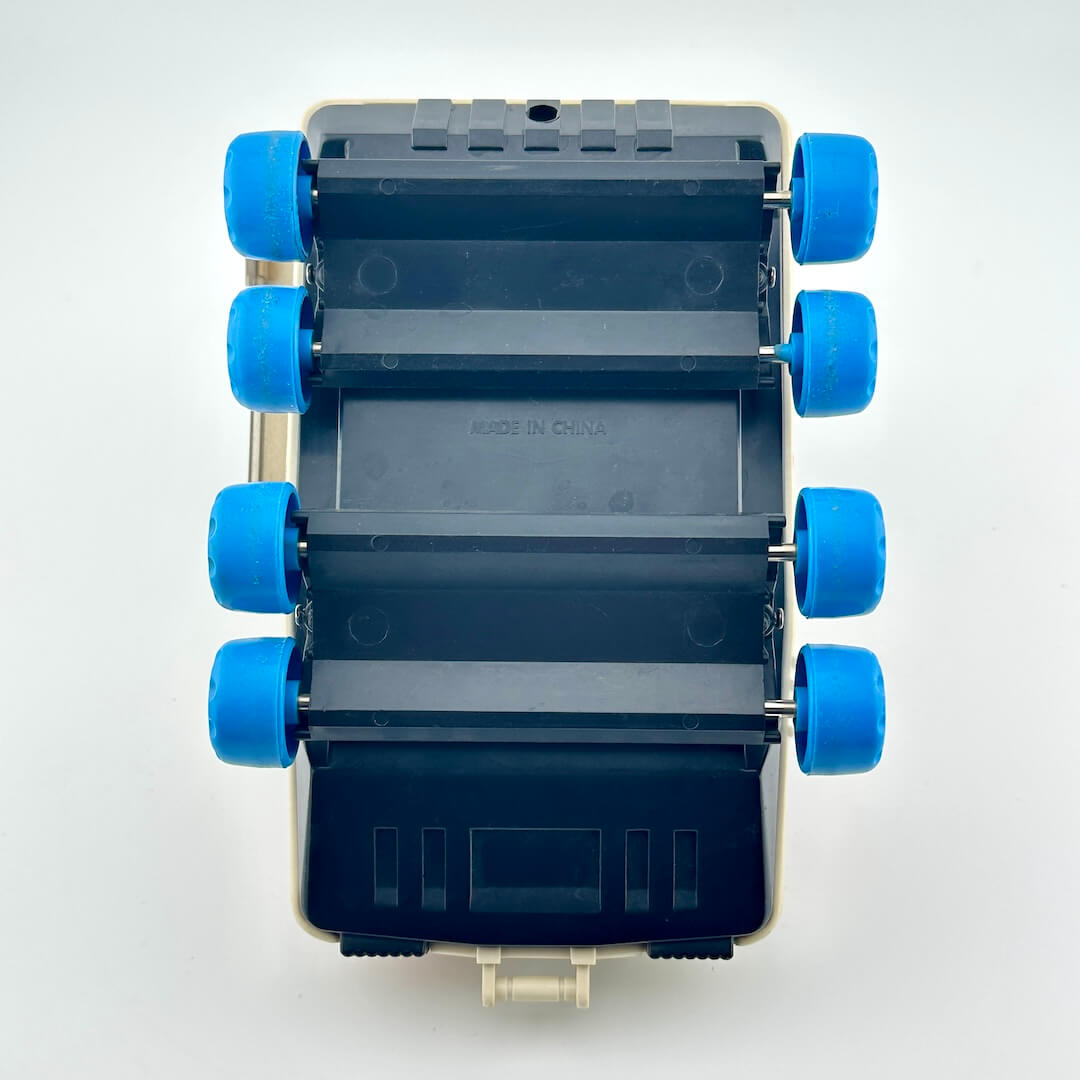 Toy moon rover with blue wheels against white background. 