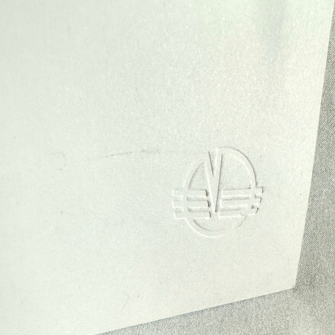 Close up of embossed stamp from angle and on reverse to see detail.