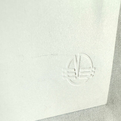 Close up of embossed stamp from angle and on reverse to see detail.