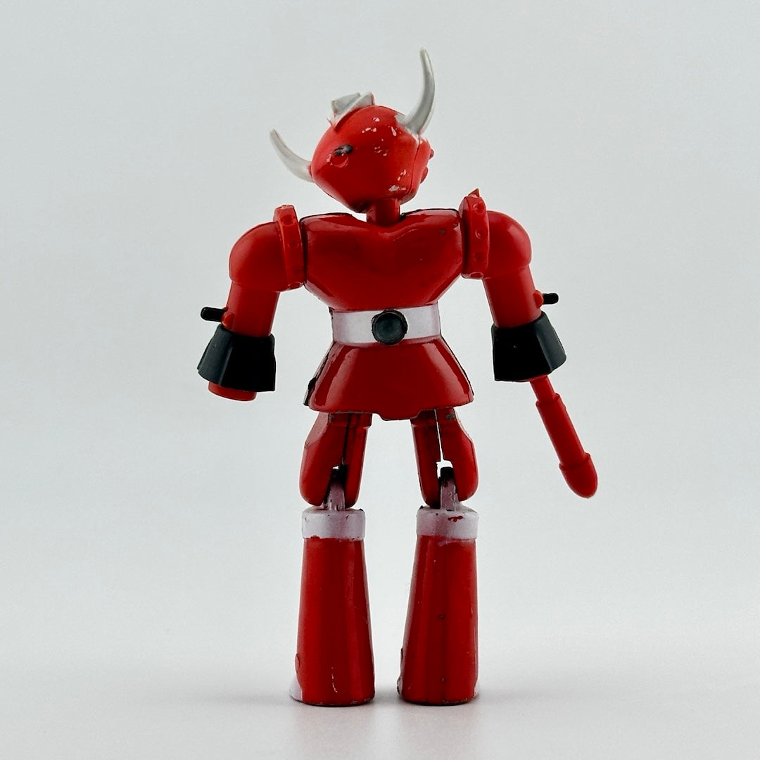 Image of red & white diecast robot with white bull horns & red attachment on left hand. White mohawk on head.