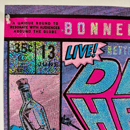 Top left corner of poster showing crisp corner, no damage to edges, glitter foil detail, event info partially visible. 