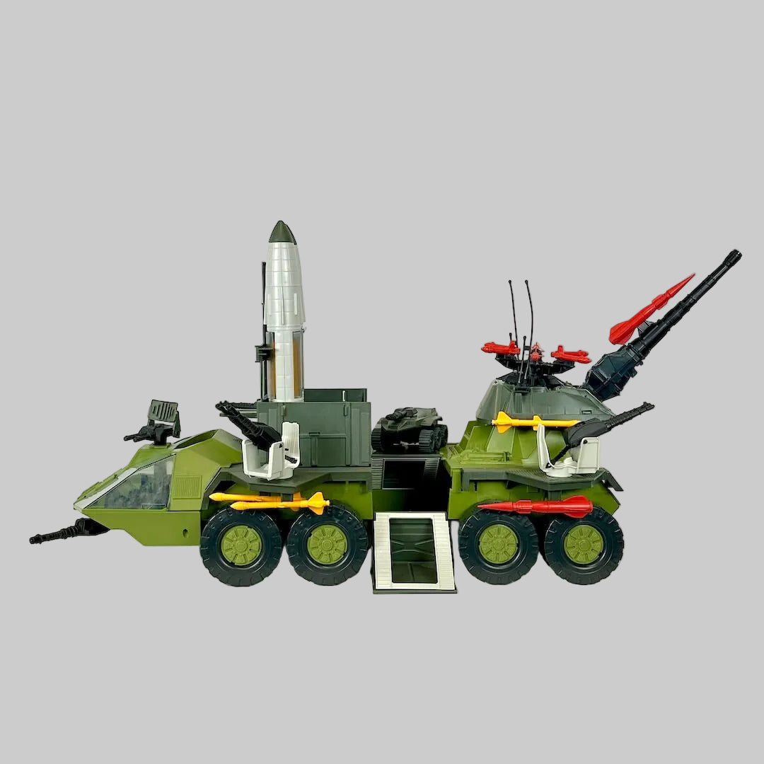 Toy vehicle with rockets, missiles, ATV, and other loose parts. 