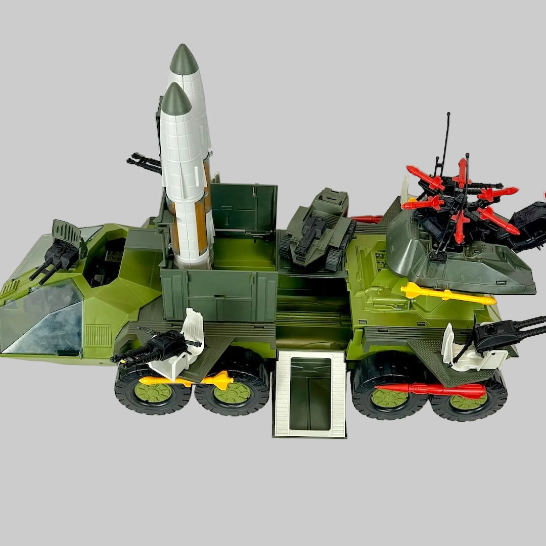 Toy model of a military vehicle with various weapons on a white background