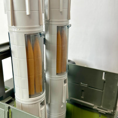 Two cylindrical objects with yellow interior components on a white background