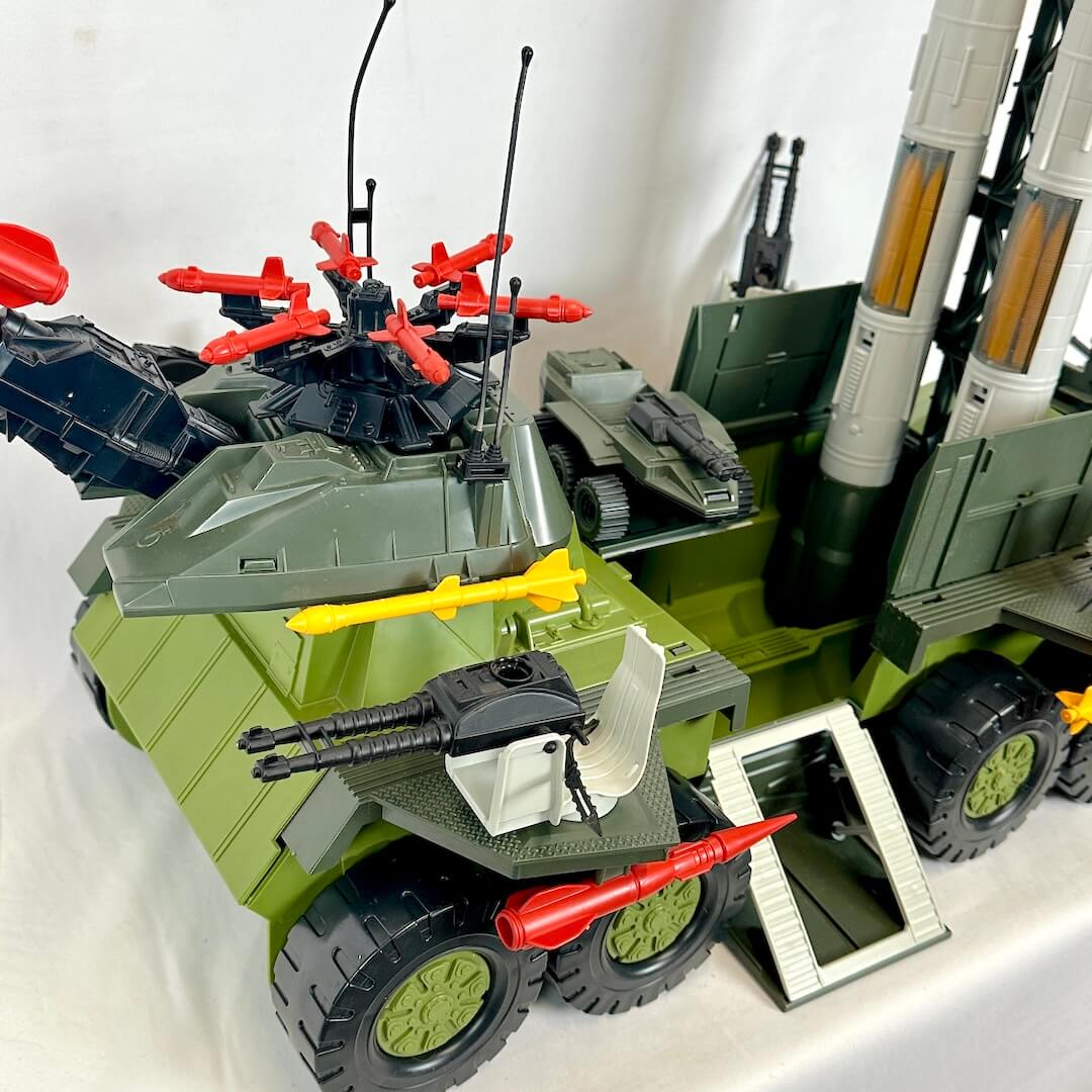 Toy military vehicle with various weapons on a white background
