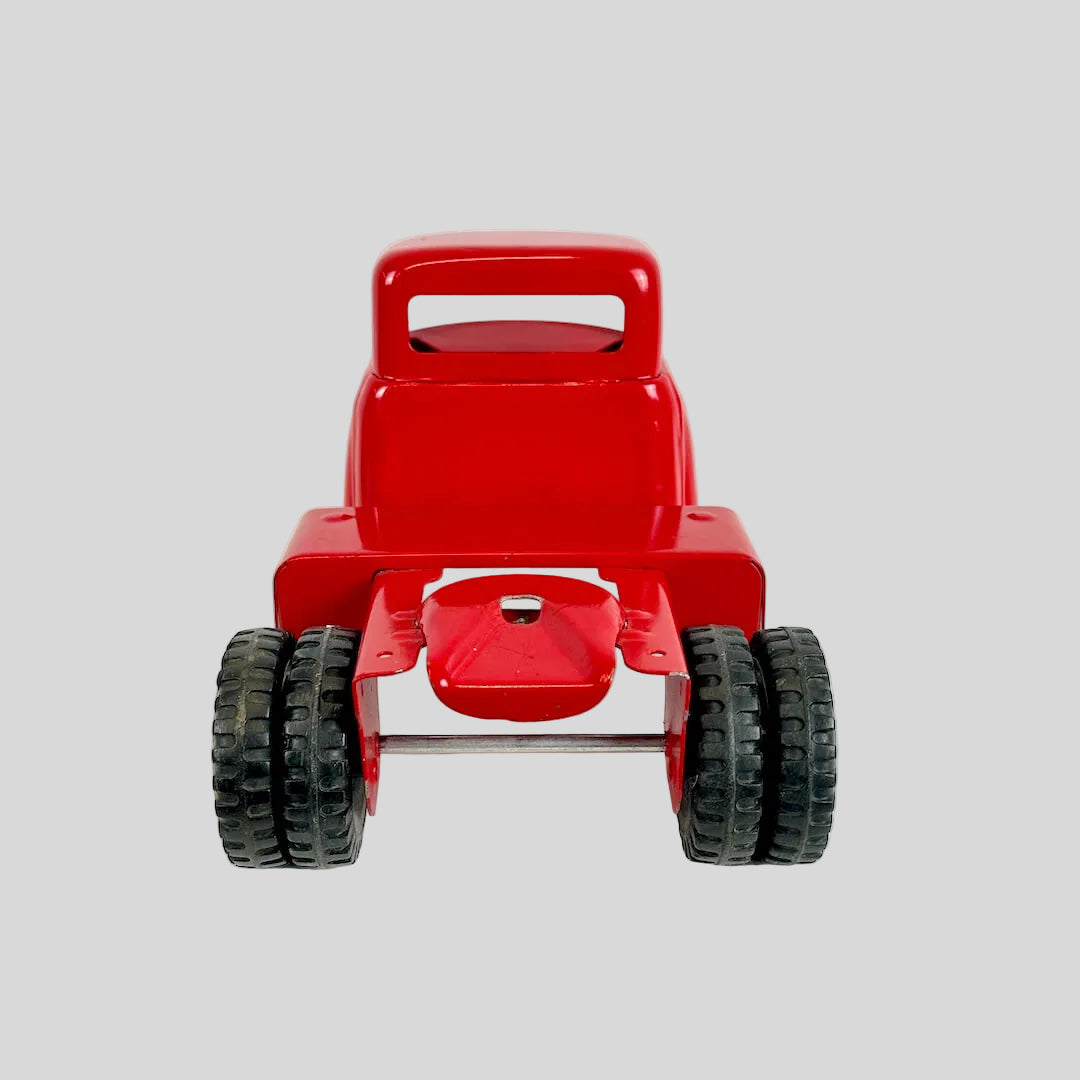 Red toy truck with black wheels on a white background