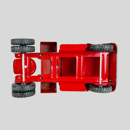 Red toy truck chassis with wheels on a white background