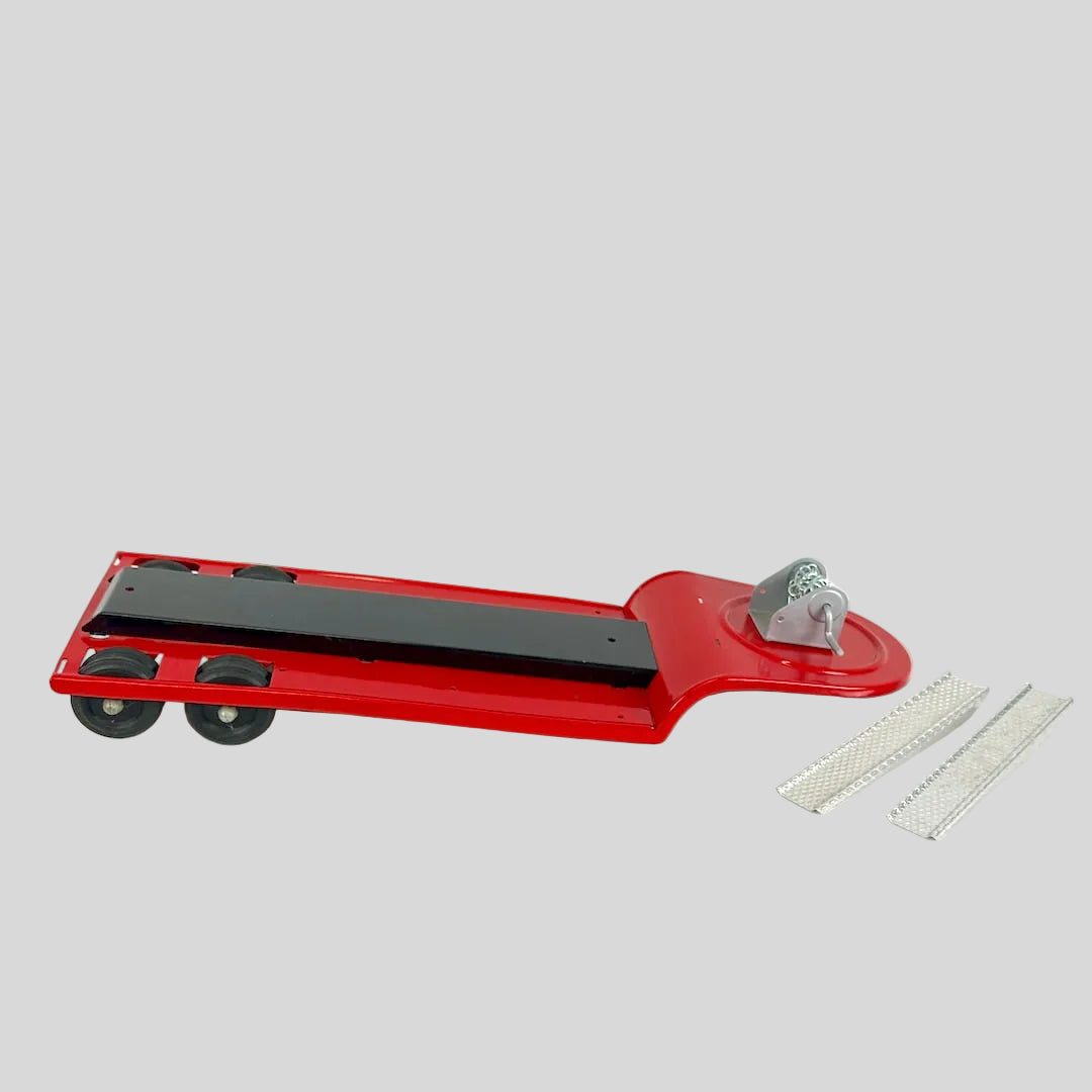 Red toy lowboy trailer with two silver loading ramps against gray background. 