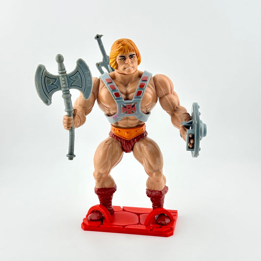 He-Man action figure with accessories against white background.