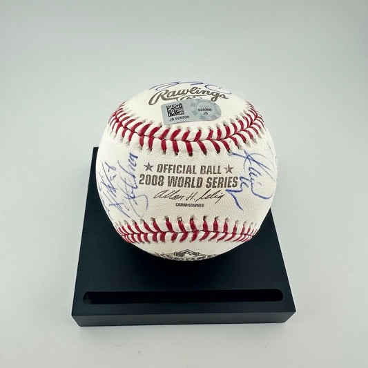 Rawlings baseball on black base with blue ballpoint pen signatures covering it. Holo JSA sticker on top. 