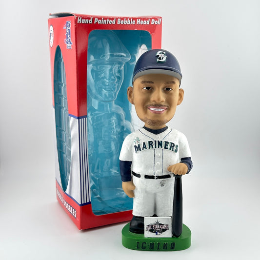 Bobblehead doll of a baseball player in a Mariners uniform with packaging in the background.