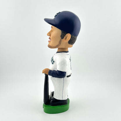 Bobblehead of a baseball player in a white uniform with a navy cap on a white background