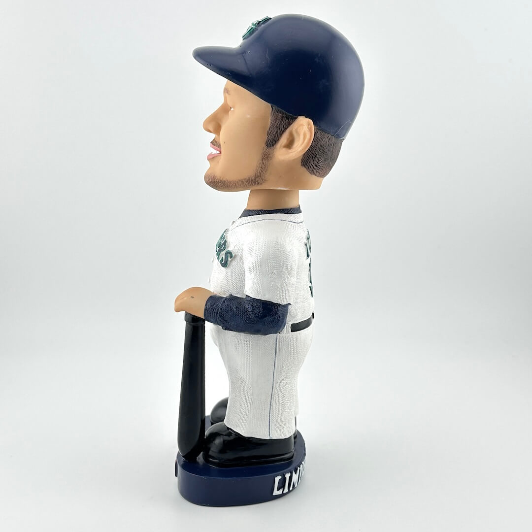 Bobblehead figure of a baseball player in a white and navy uniform with a helmet on a white background
