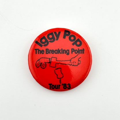 Red button with black text and graphic, featuring 'Iggy Pop The Breaking Point Tour '83' on a white background.