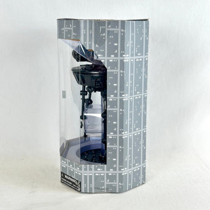 A boxed collectible figure inside a tall, narrow retail package with a clear front window. 
