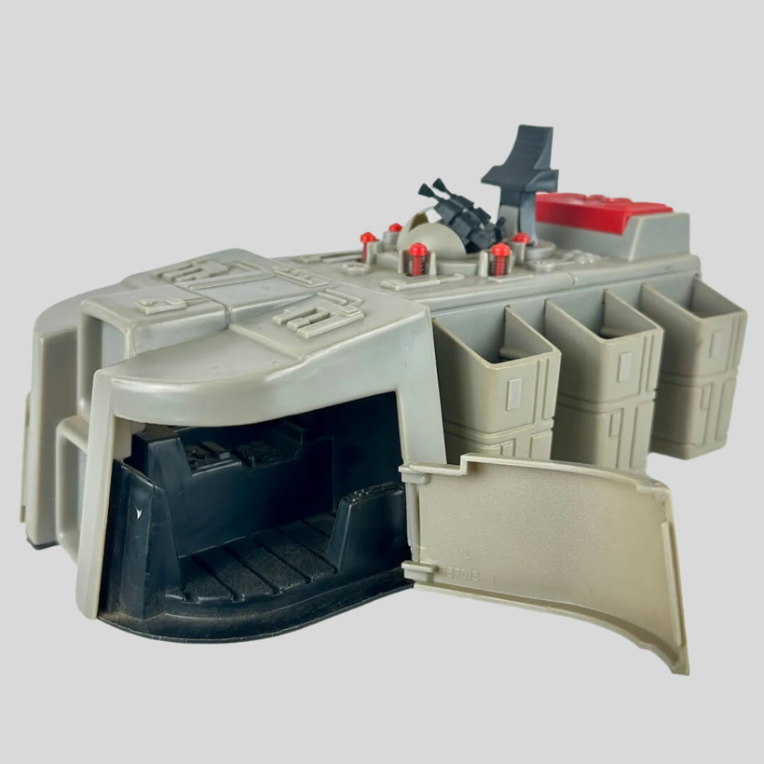 Toy model of a spaceship or vehicle with open doors on a white background