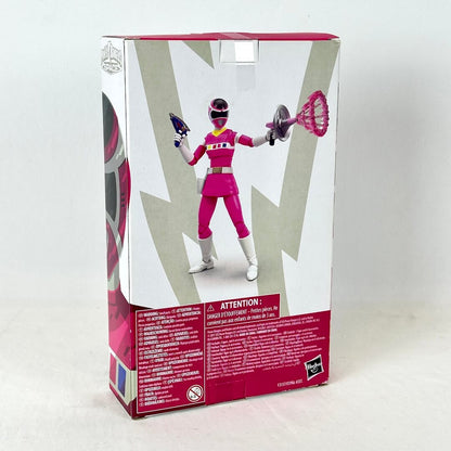 Back of packaging with image of posed action figure above warning labels and product information. 