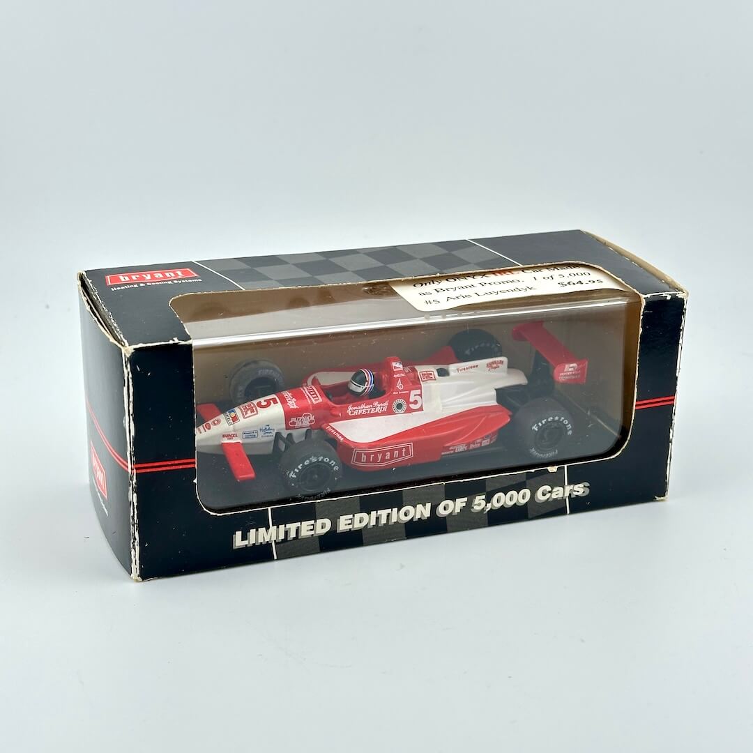 Model car in a box with a limited edition label on a gray background