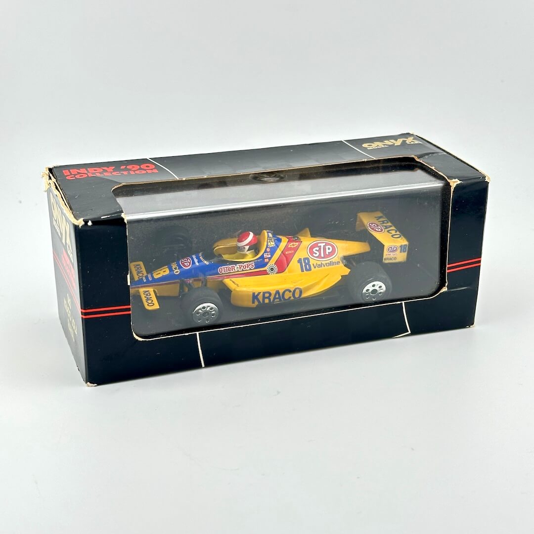 Model car in a box with visible branding on a white background